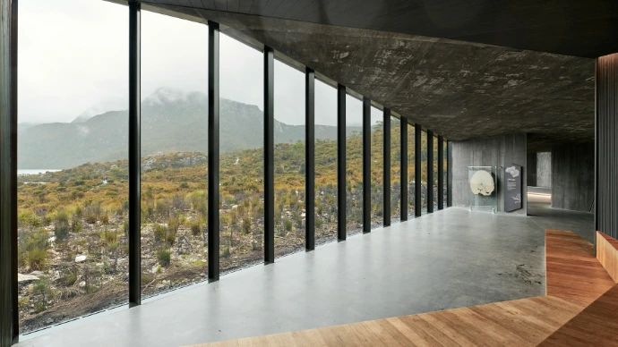 Modern building with large windows overlooking autumn landscape